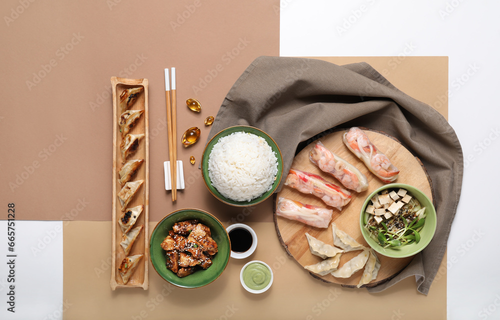 Composition with different Chinese dishes on color background