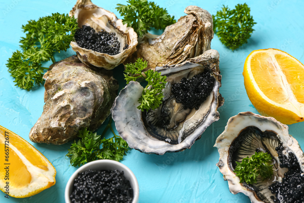 Tasty oysters with lemon and black caviar on blue background