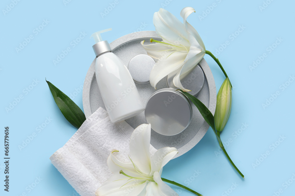 Composition with different cosmetic products, clean towel and beautiful lily flowers on color background