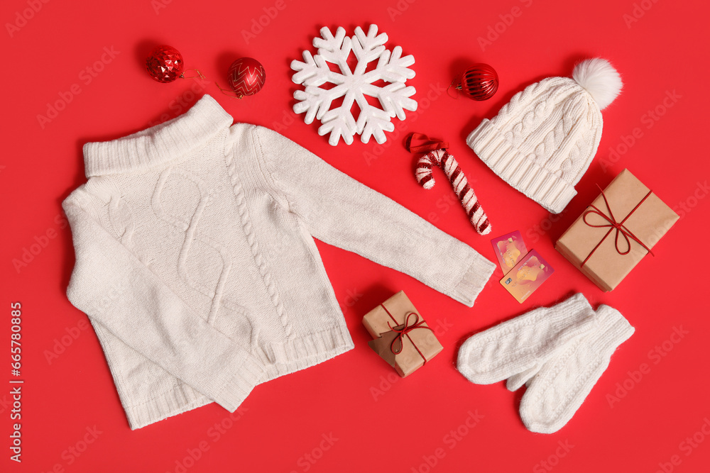 Composition with stylish female clothes, Christmas decorations and credit cards on red background