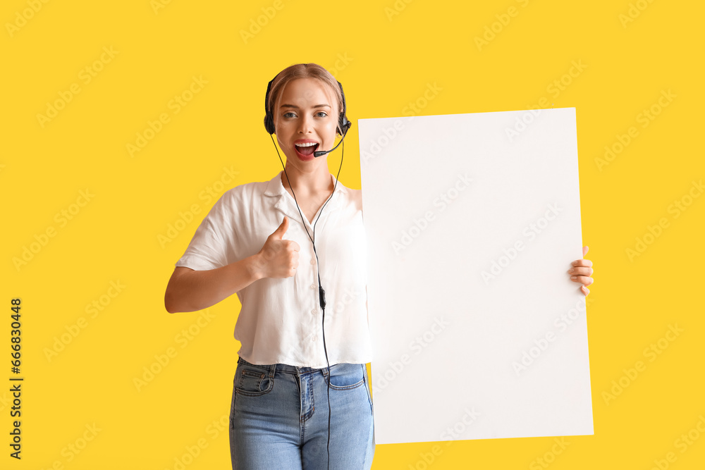 Female technical support agent with blank poster showing thumb-up on yellow background