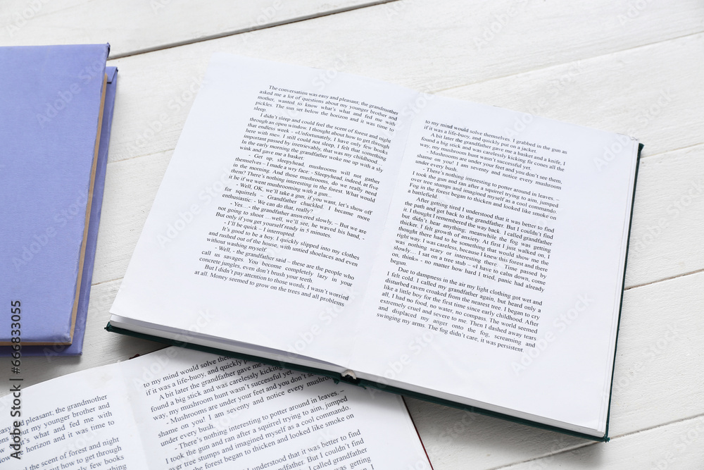 Open book on white wooden table