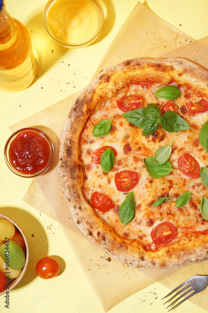 Baking paper with tasty pizza Margarita and basil on yellow background