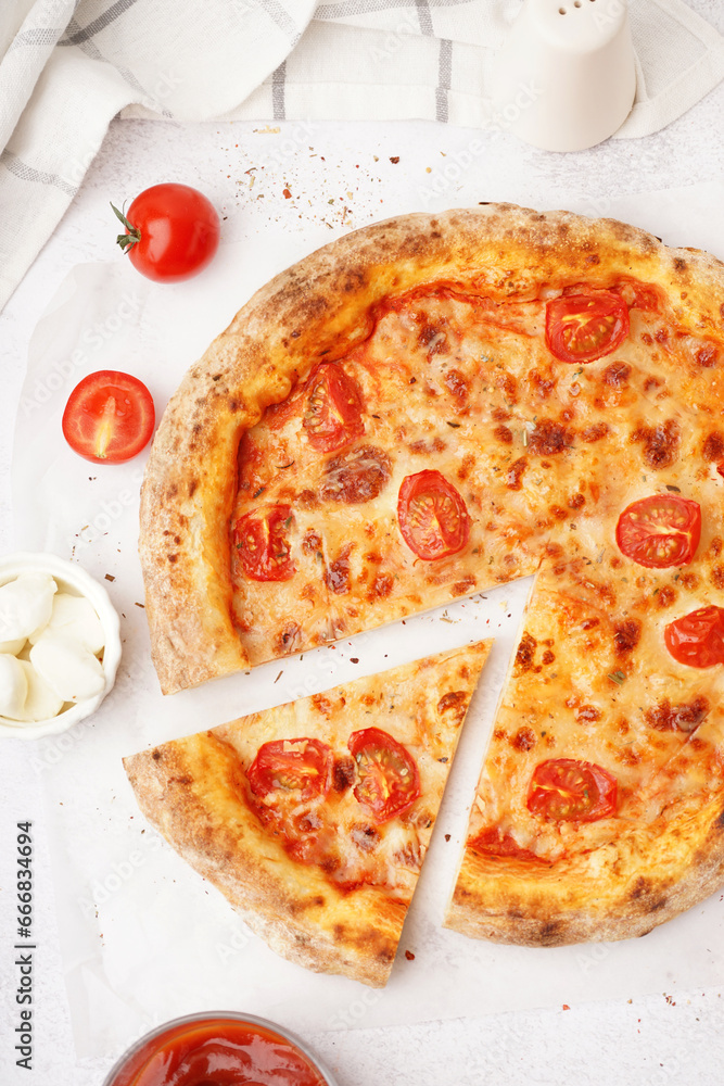 Tasty pizza Margarita with tomatoes and bowl of mozzarella on white table