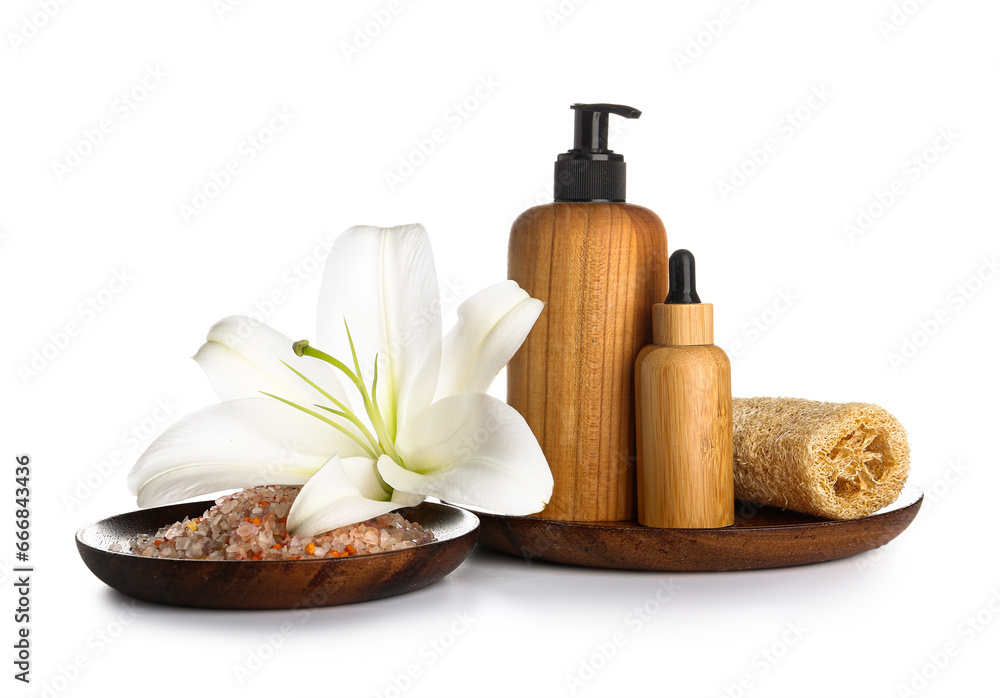 Spa composition with cosmetic products and lily flower on white background