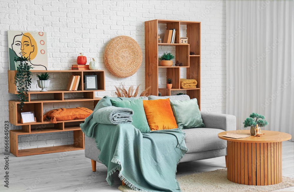 Interior of stylish living room with sofa, table and shelf units