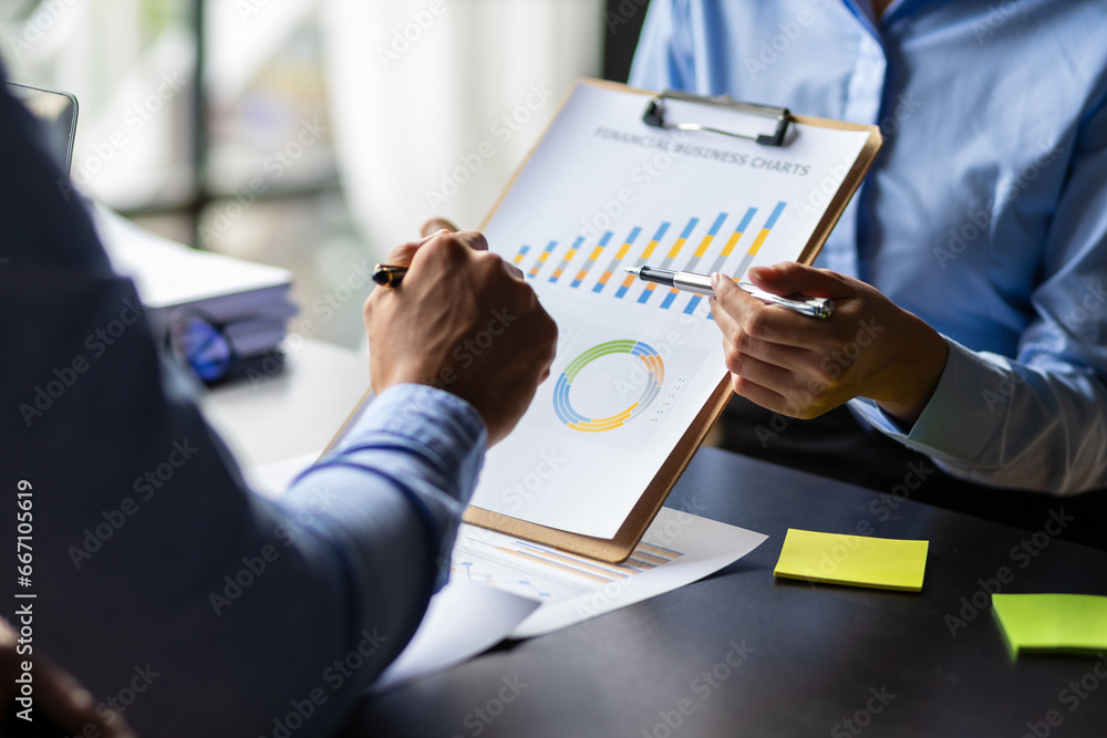 Meeting of financial advisors to discuss and analyze the graph growth in the business chart report to plan marketing and investment strategies.