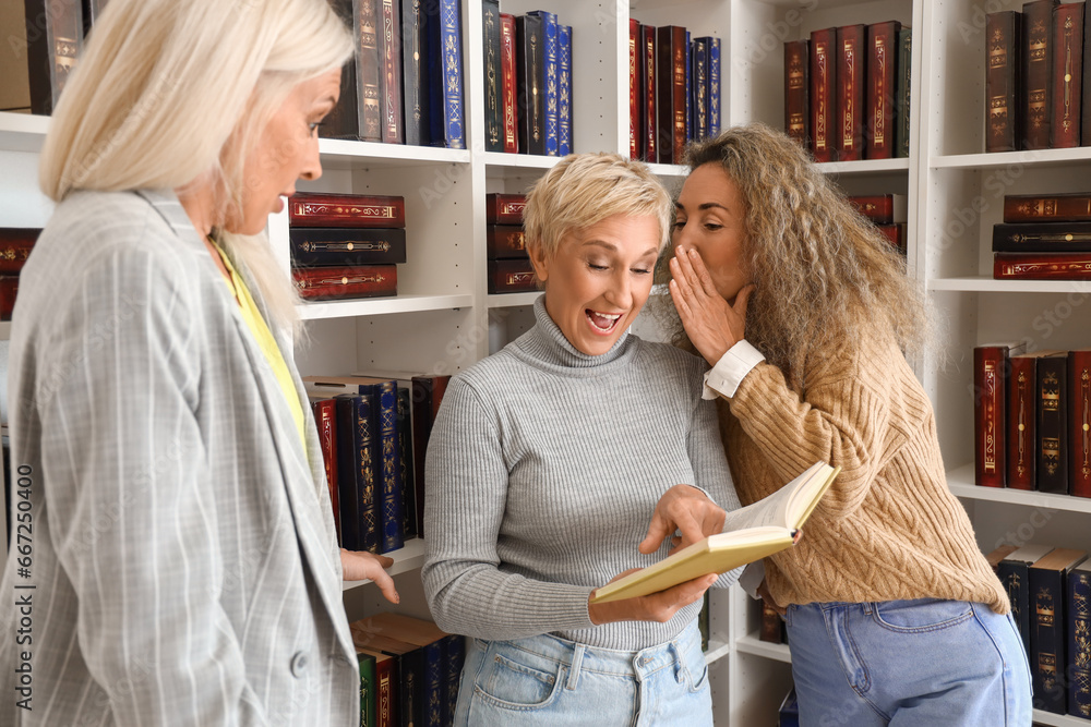 Mature women reading book at home library