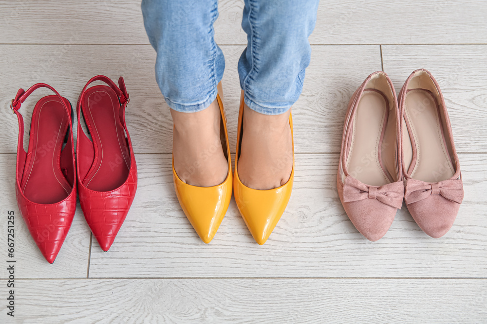 Woman with different shoes standing on floor in store