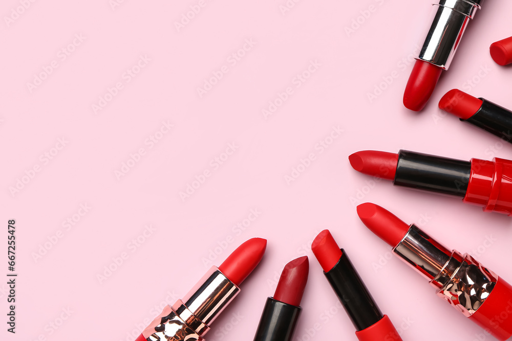 Different bright lipsticks on pink background