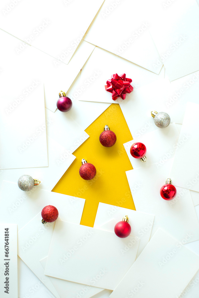 Abstract Christmas tree and Christmas ornaments on white background overhead view still life.