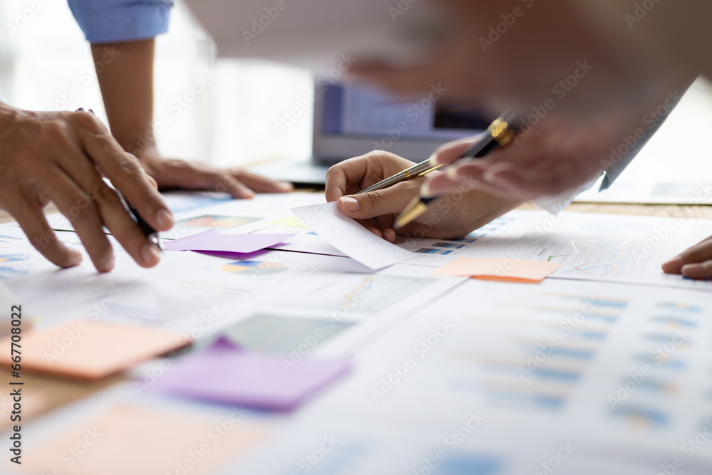 Business people discuss marketing growth chart and make business plan. Business meeting, financial consultants brainstorm analysis of statistical charts in financial reporting documents.