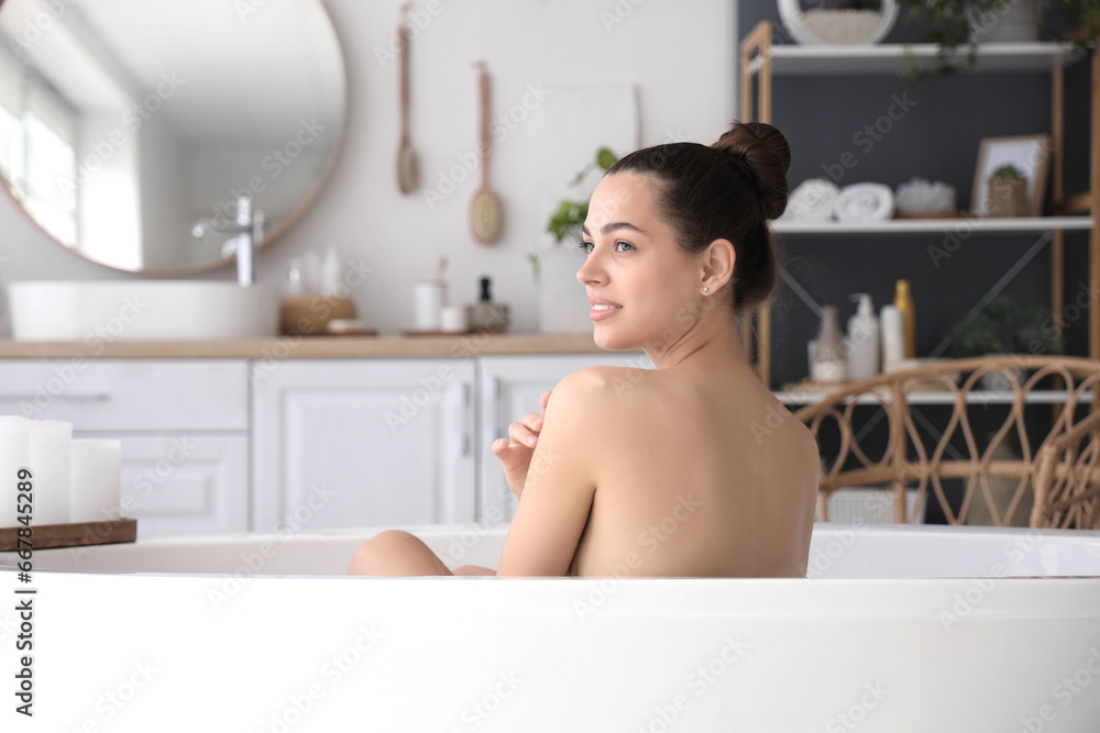 Young woman taking bath at home