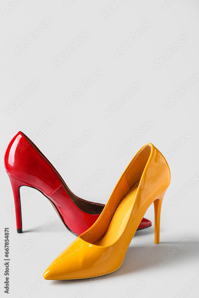 Different stylish high heels on white background