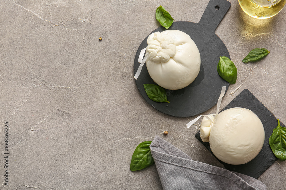 Boards with tasty Burrata cheese on grey background