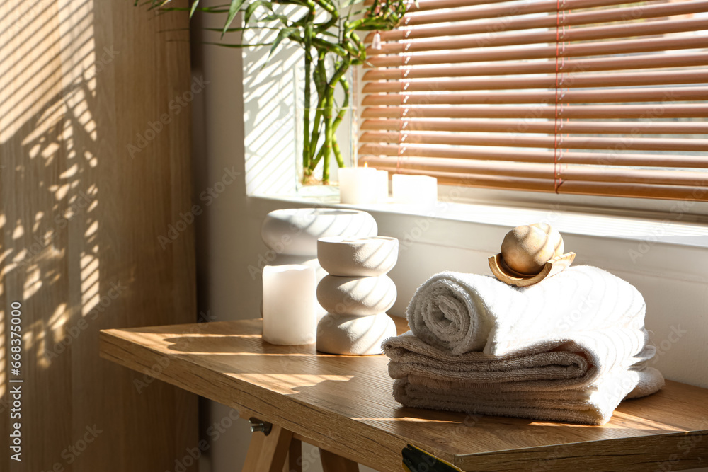 Towels with massage balls on table in spa salon, closeup