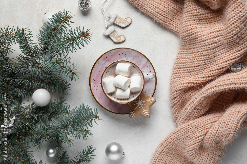 Cup of tasty Christmas cocoa with marshmallows, fir branches, sweater, balls and cookie on white background