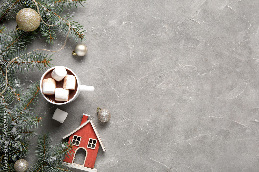 Cup of tasty cocoa with marshmallows and Christmas decor on grey background