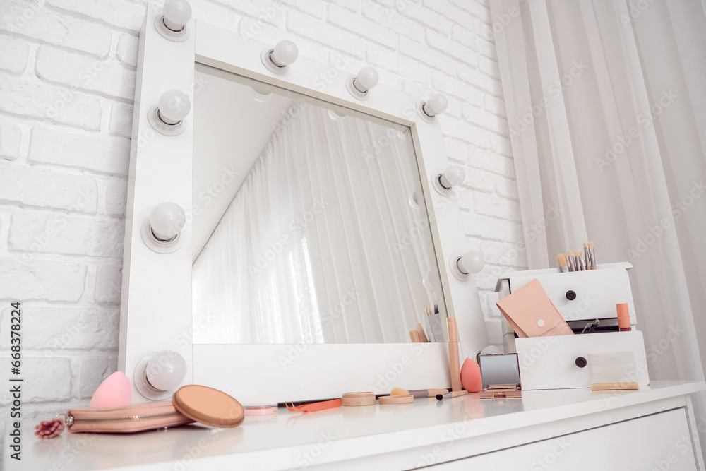 Drawers with cosmetics and mirror in makeup room