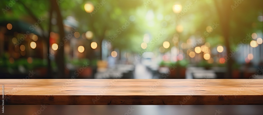 Product display montage with empty brown wooden table and coffee shop blur background featuring bokeh