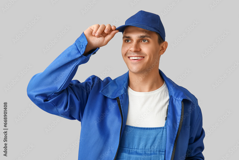 Male car mechanic on grey background