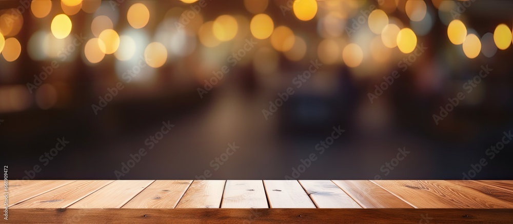 Wooden table in front of blurred bokeh background of cafe and restaurant for product display or montage Mock up for space