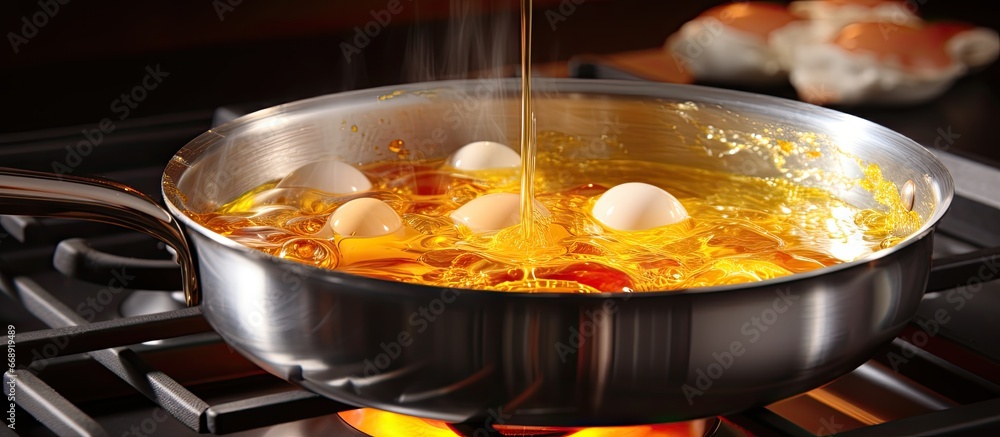 Closeup of boiled egg above saucepan on electric stove