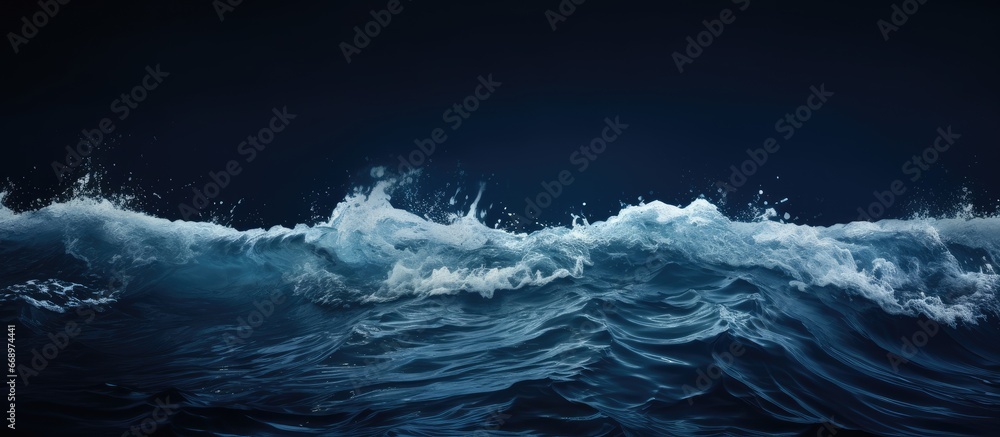 Photograph of the stunning foamy dark sea water surface captured horizontally in color