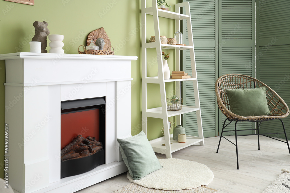 Interior of living room with electric fireplace and shelf unit