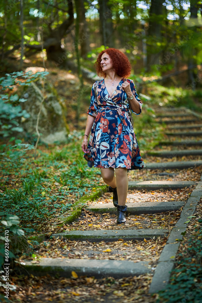 Curly redhead lady in the park