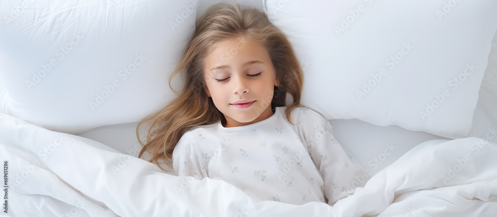 Girl in bed wearing white pajamas alone