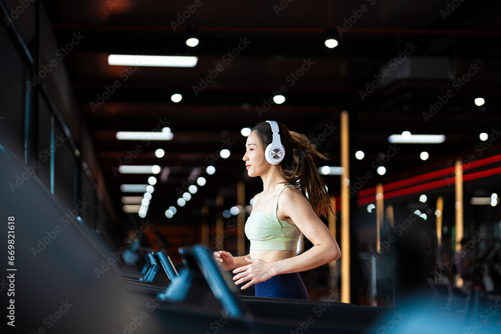 Young Asian Woman Running on Treadmill - Fitness Gym Exercise