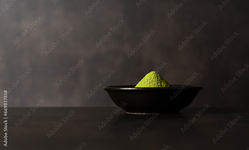 Matcha powder on dark background.