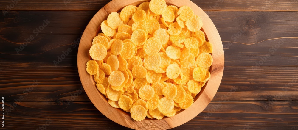 Circular arrangement of corn flakes on wooden dish