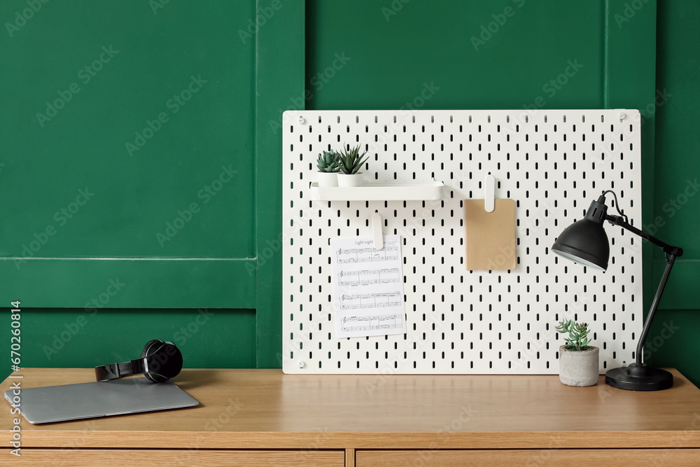 Musicians workplace with pegboard in office