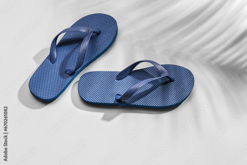 Female stylish flip flops on grey background