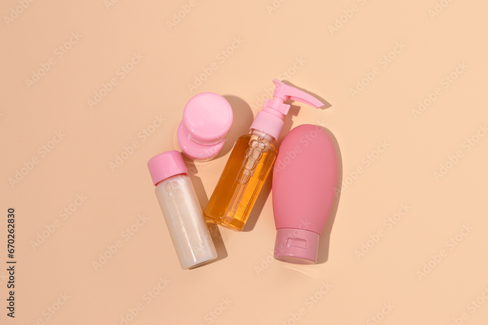 Set of travel cosmetic products on orange background