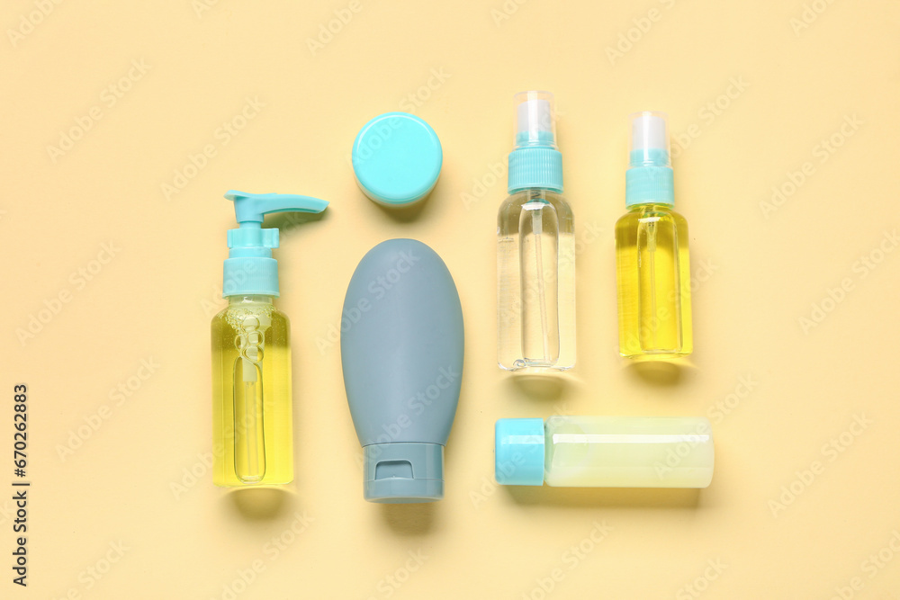 Set of travel cosmetic products on yellow background