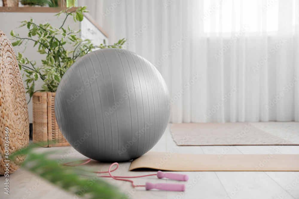 Fitness ball with skipping rope and yoga mat at home