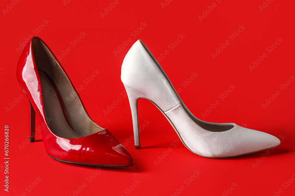 Different stylish high heels on red background