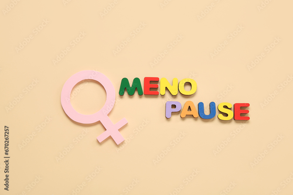 Word MENOPAUSE with symbol of woman on beige background