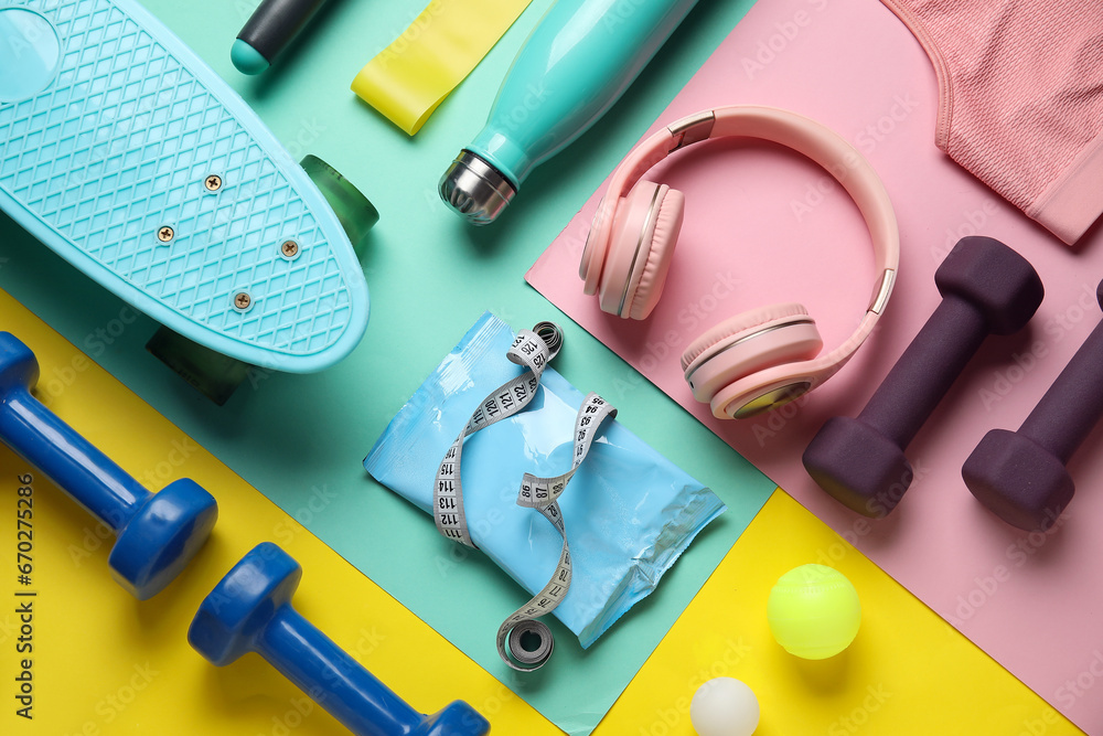 Composition with healthy snack, modern headphones and sports equipment on color background