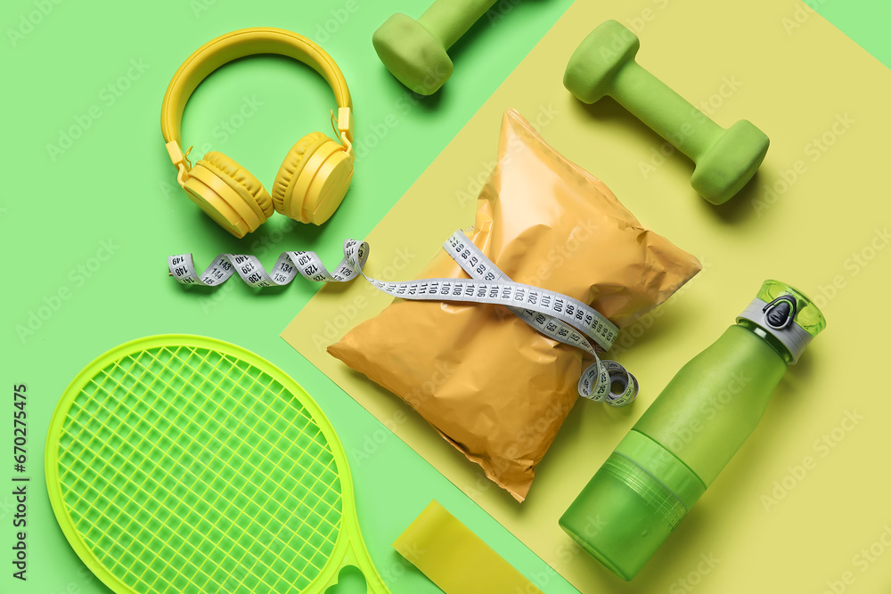 Composition with healthy snack, sports equipment and headphones on color background