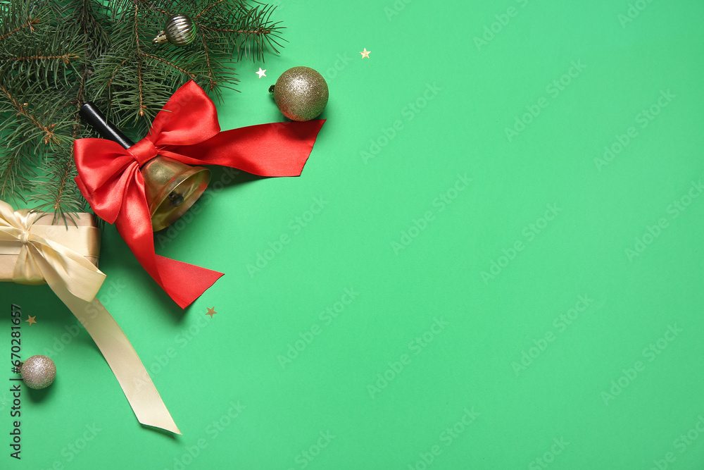 Christmas bell with fir branches and gift box on green background