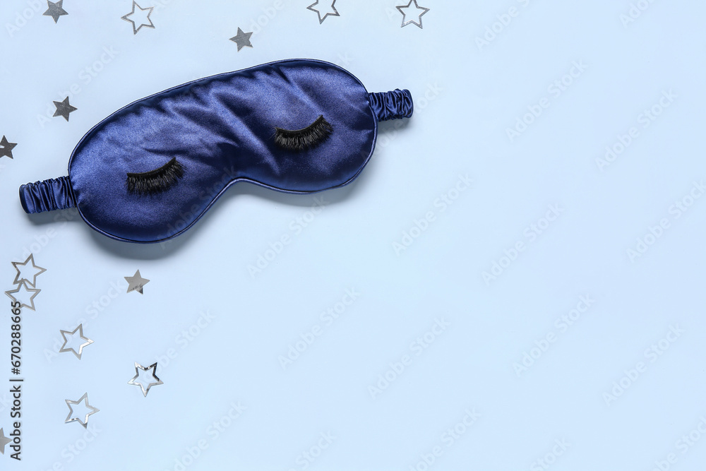 Composition with sleep mask, false eyelashes and stars on color background