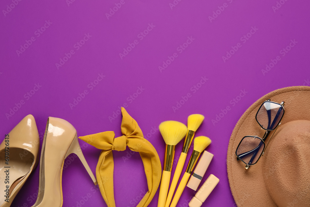 Composition with female accessories, cosmetics and high heeled shoes on purple background