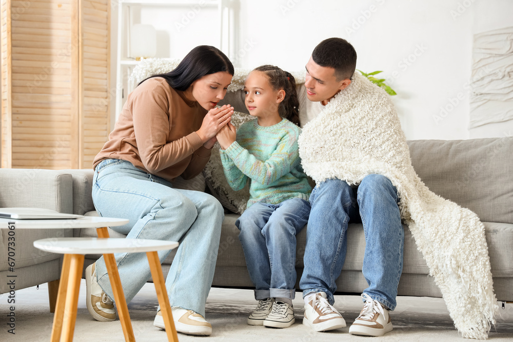 Frozen family with lack of heating warming hands at home