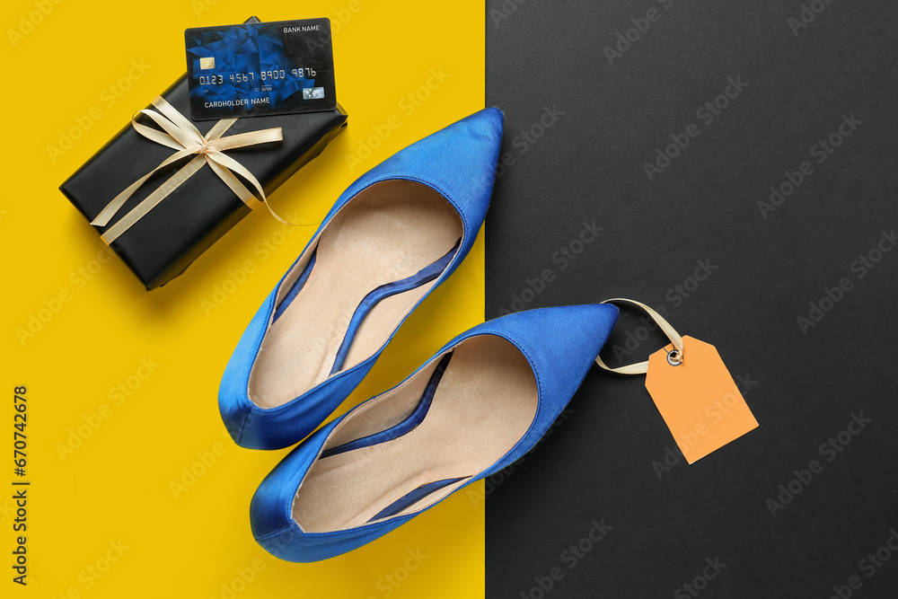 Stylish high heeled shoes, gift box and credit card on color background. Black Friday sale