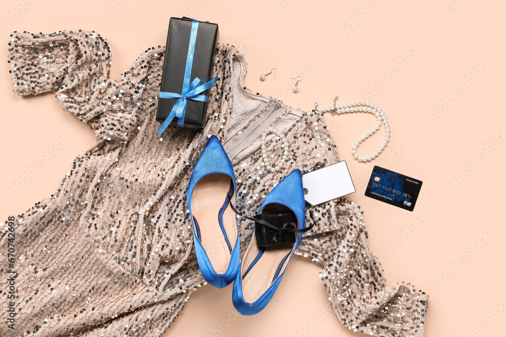 Composition with stylish female shoes, dress, gift boxes and blank tag on color background. Black Friday sale