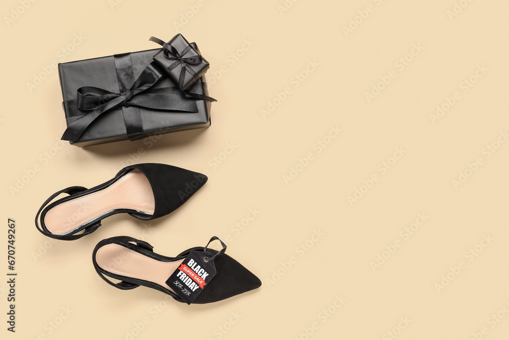 Pair of stylish female shoes, gift boxes and sale tag on color background. Black Friday